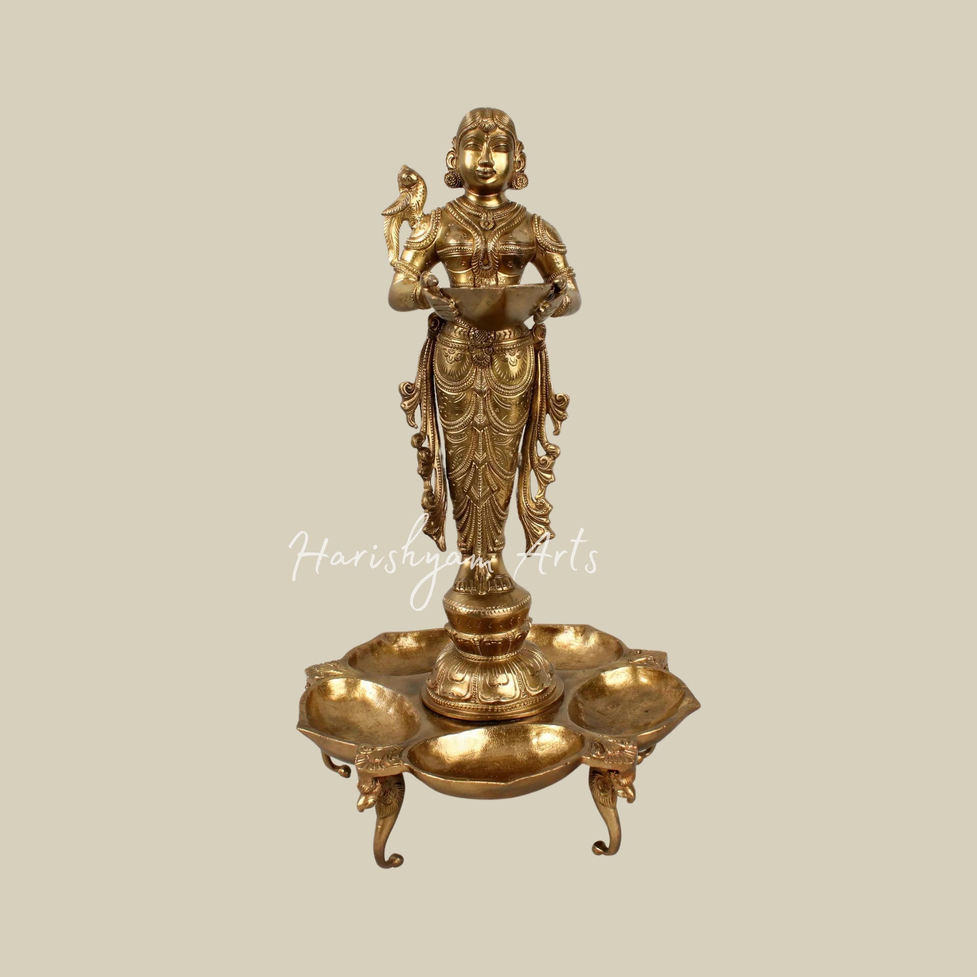 17" Graceful Deepalakshmi Holding a Lamp on a Tray of Lamps