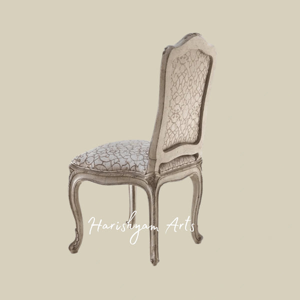 Traditional European Upholstered Chair with Intricate Carvings, Timeless Fabric Design, and Sturdy Wooden Legs